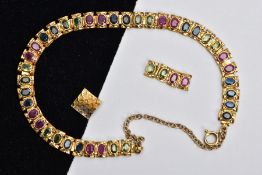 A YELLOW METAL MULTI GEM SET LINE BRACELET, designed with square links each set with alternating