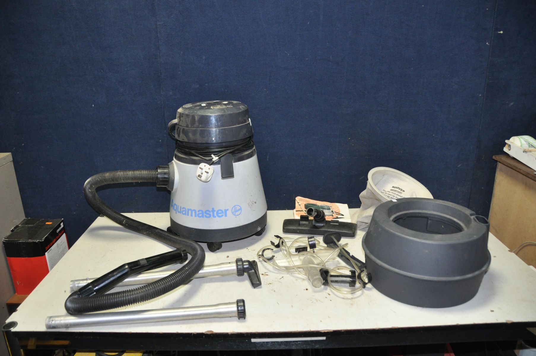 A HOOVER AQUAMASTER WET AND DRY VACUUM CLEANER with reservoir, head and pipework for carpet