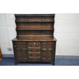 A DARK ERCOL ELM OLD COLONIAL DRESSER, with plate rack to top, base with two cupboard doors flanking