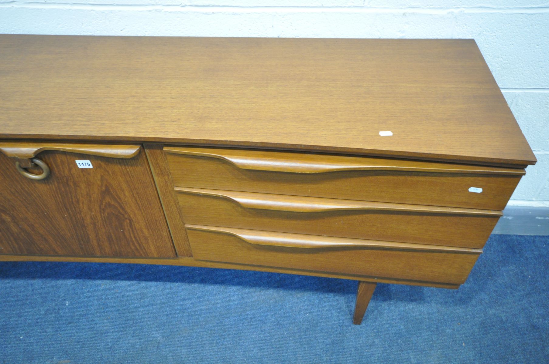 A MID CENTURY BEAUTILITY TEAK CONCAVE SIDEBOARD, with three graduated drawers, the top drawer with - Image 3 of 3
