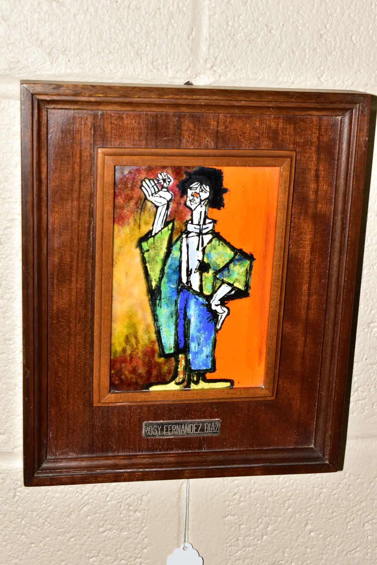 AFTER PABLO PICASSO 'PAUL AS PIERROT', a wood framed enamel plaque depicting the artists son dressed