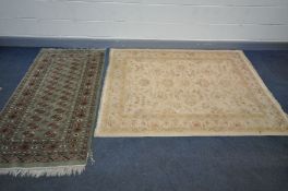 A MODERN CREAM WOLLEN RUG, 195cm x 140cm, and a green Tekke rug, 165cm x 94cm (2)