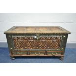 AN EASTERN HEAVILY CARVED HARDWOOD BLANKET BOX with brass adornments, internal candle box and