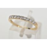 A 9CT GOLD DIAMOND HALF ETERNITY RING, designed with a row of nine claw set round brilliant cut