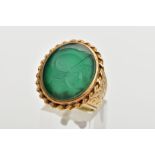 A GENTS 9CT GOLD INTAGLIO RING, of an oval form, engraved soldiers head within a green chalcedony,