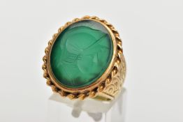 A GENTS 9CT GOLD INTAGLIO RING, of an oval form, engraved soldiers head within a green chalcedony,