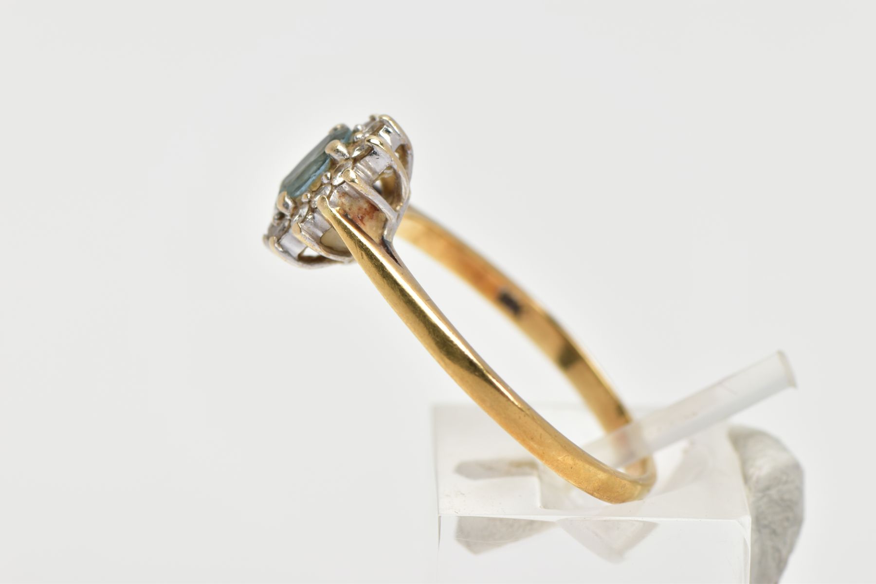 AN 18CT GOLD GEM SET CLUSTER RING, of an oval form, centring on an oval cut aquamarine, within a - Image 2 of 4
