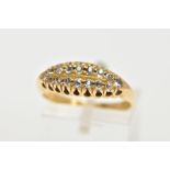 AN 18CT GOLD DIAMOND BOAT RING, a yellow gold ring set with sixteen old cut diamonds, leading onto a