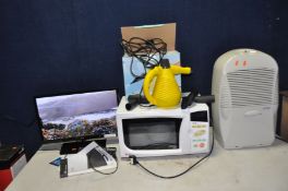 A LOGIK L22FE14 22in TV with remote, a LG microwave, a Eurodry Dehumidifier and a Lervia Steam