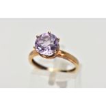A AMETHYST SOLITAIRE RING, a circular cut amethyst, approximate diameter 9mm, set in a yellow