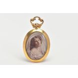 A 9CT GOLD PHOTO PENDANT, an oval pendant fitted with a scroll detail screw bail, a colour