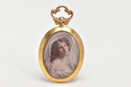 A 9CT GOLD PHOTO PENDANT, an oval pendant fitted with a scroll detail screw bail, a colour