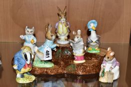 SEVEN BESWICK BEATRIX POTTER CHARACTERS AND A BESWICK TREE STUMP DISPLAY STAND, comprising 'Peter