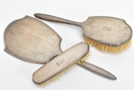 THREE SILVER VANITY PIECES, comprising of a mirror, hair brush and clothes brush, each with an