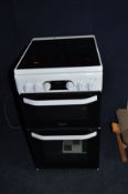A HOTPOINT HD5V93CCW/UK ELECTRIC COOKER with ceramic four ring hob, grill and oven (condition:- very