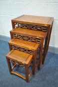 A 20TH CENTURY HUANGUALI NEST OF FOUR TABLES, the rectangular tops above foliate carved and
