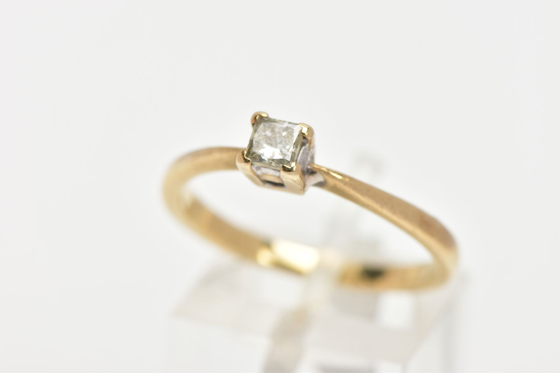 A YELLOW METAL SINGLE STONE DIAMOND RING, four claw set princess cut diamond, stamped diamond weight