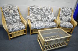 A WICKER FOUR PIECE CONSERVATORY SUITE, with floral cushions, comprising of a sofa, two armchairs