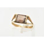 A SMOKEY QUARTZ DRESS RING, rectangular cut Smokey quartz stone, set in a yellow metal bezel