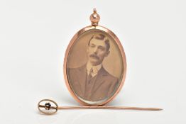 A DOUBLE SIDED PHOTO LOCKET AND A STICK PIN, the photo locket of an oval form, inserted with a photo