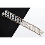 A WHITE METAL MOONSTONE BRACELET, designed with two rows of oval cabochon moonstones each collet