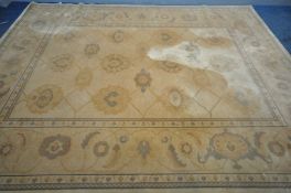 A LARGE GOLD UPHOLSTERED CARPET SQUARE, 366cm x 274cm (condition:-stain to centre of rug)