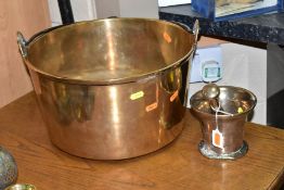 A BRASS JAM KETTLE AND A COPPER PESTLE AND MORTAR, the jam kettle with an iron loop handle, diameter