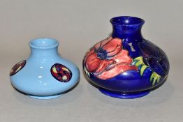 A MOORCROFT POTTERY SQUAT BALUSTER VASE DECORATED WITH PINK AND PURPLE ANEMONES ON A BLUE GROUND,