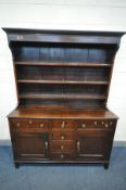 A GEORGE II OAK DRESSER, the triple tier plate rack top, the base with three drawers, over two