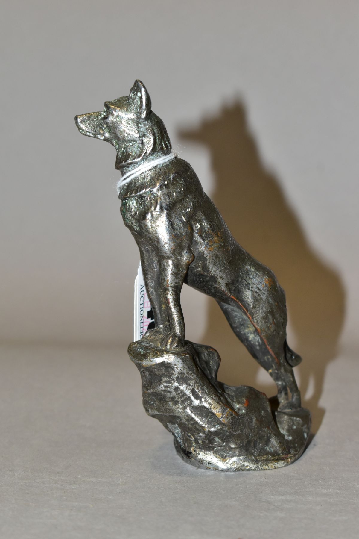 A CHROMED METAL CAR MASCOT IN THE FORM OF AN ALSATIAN STANDING WITH ITS FRONT LEGS ON A ROCK, - Image 3 of 6
