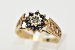 A SAPPHIRE AND DIAMOND CLUSTER RING, four circular cut sapphires surrounding a round brilliant cut