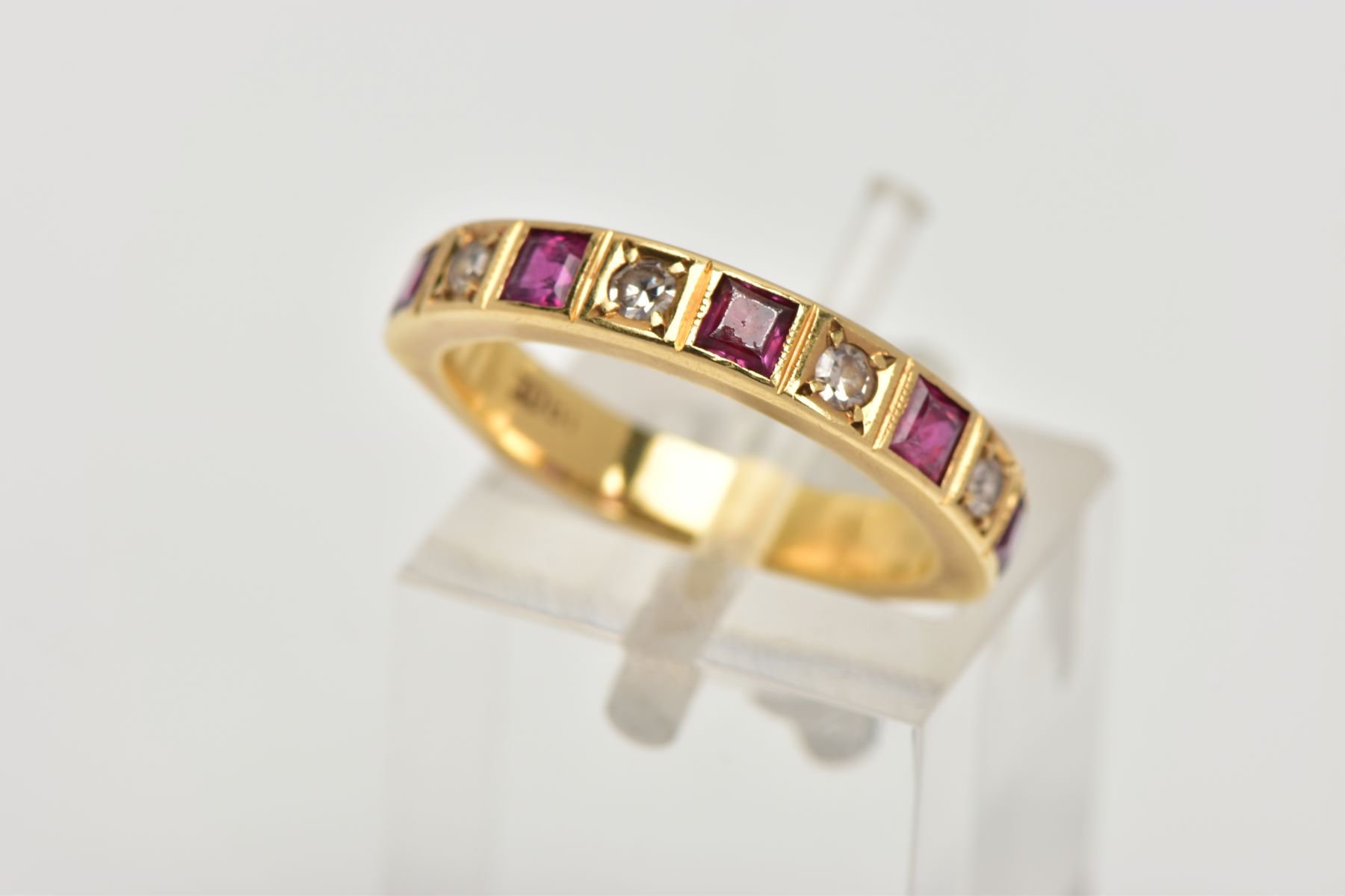 A DIAMOND AND RUBY HALF ETERNITY RING, five square cut rubies and four round brilliant cut