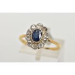 A SAPPHIRE AND DIAMOND RING, an oval cut sapphire bezel set with ten round brilliant cut diamonds,