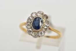 A SAPPHIRE AND DIAMOND RING, an oval cut sapphire bezel set with ten round brilliant cut diamonds,