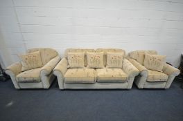 A FLORAL BEIGE UPHOLSTERED THREE PIECE SUITE, comprising a three seater sofa, length 200cm, and a