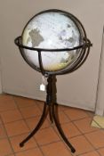 A MODERN GLOBE ON A METAL STAND, standing on three feet, dated 2008, total height approximately 83cm