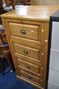 A LIGHT WOOD FOUR DRAWER FILING CABINET