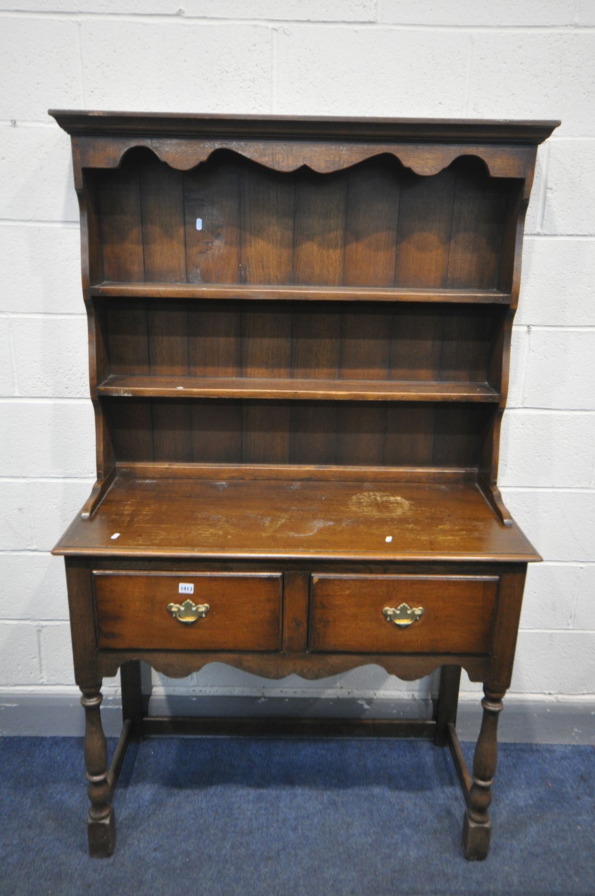 AN OAK DRESSER, with two drawers, on turned front legs, width 107cm x depth 46cm height 176cm (