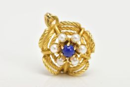 A YELLOW METAL FLORAL GEM SET PENDANT, a lapis lazuli centre surrounded by six seed pearls prong set