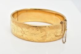 A 9CT ROLLED GOLD BANGLE, wide hinged bangle with an engraved floral pattern, approximate width 18.