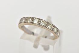 A NINE STONE DIAMOND RING, nine round brilliant cut diamonds grain set in a white metal mount,