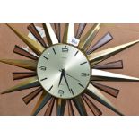 A MID TWENTIETH CENTURY METAMEC SUNBURST WALL CLOCK, with original box, the clock having faux teak