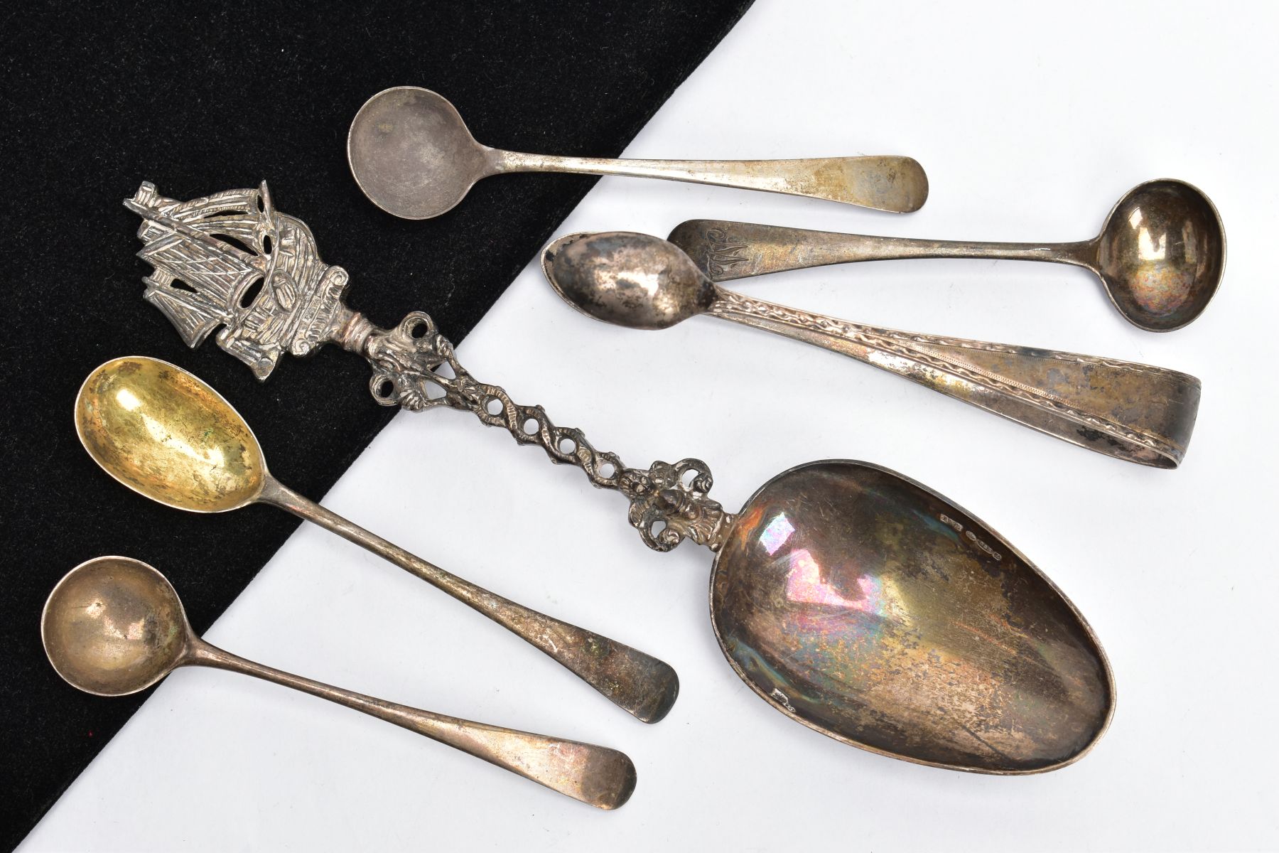 A BAG OF SILVER AND WHITE METAL SPOONS AND A PAIR OF SUGAR TONGS, to include four Georgian old