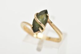 A 9CT GOLD GEM SET RING, a green marquise cut stone assessed as tourmaline, prong set with a band of