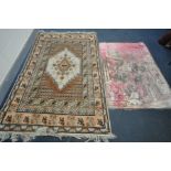 A BROWN WOOLLEN RUG, 240cm x 153cm, and a pink Arabic scene tapestry, 165cm x 112cm (2)