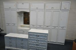 A WHITE BEDROOM SUITE, comprising a five section wardrobe fitment with top storage sections, a chest