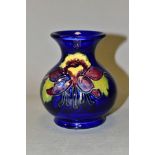 A SMALL MOORCROFT POTTERY COLUMBINE VASE, of globular form, with tubelined purple, yellow and