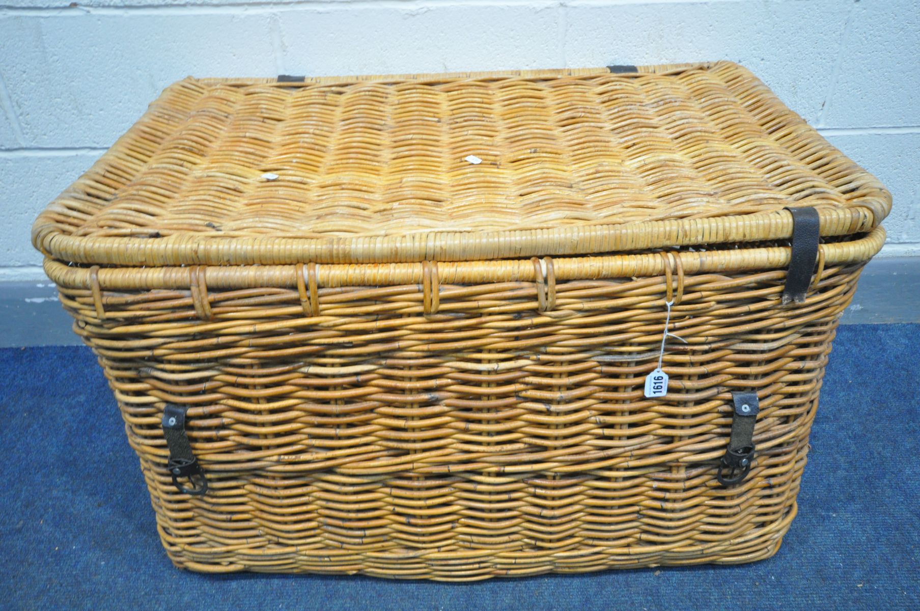 A LARGE WICKER BASKET, with handles, width 90cm x depth 58cm x height 53cm (condition:-leather