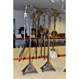 A PAIR OF EARLY 20TH CENTURY BRONZE AND IRON FIRESIDE COMPANION SETS, each stand cast with roses and