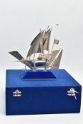 A WHITE METAL BOAT FIGURINE, plain polished sailing boat figurine, detailed with ropes, anchor,